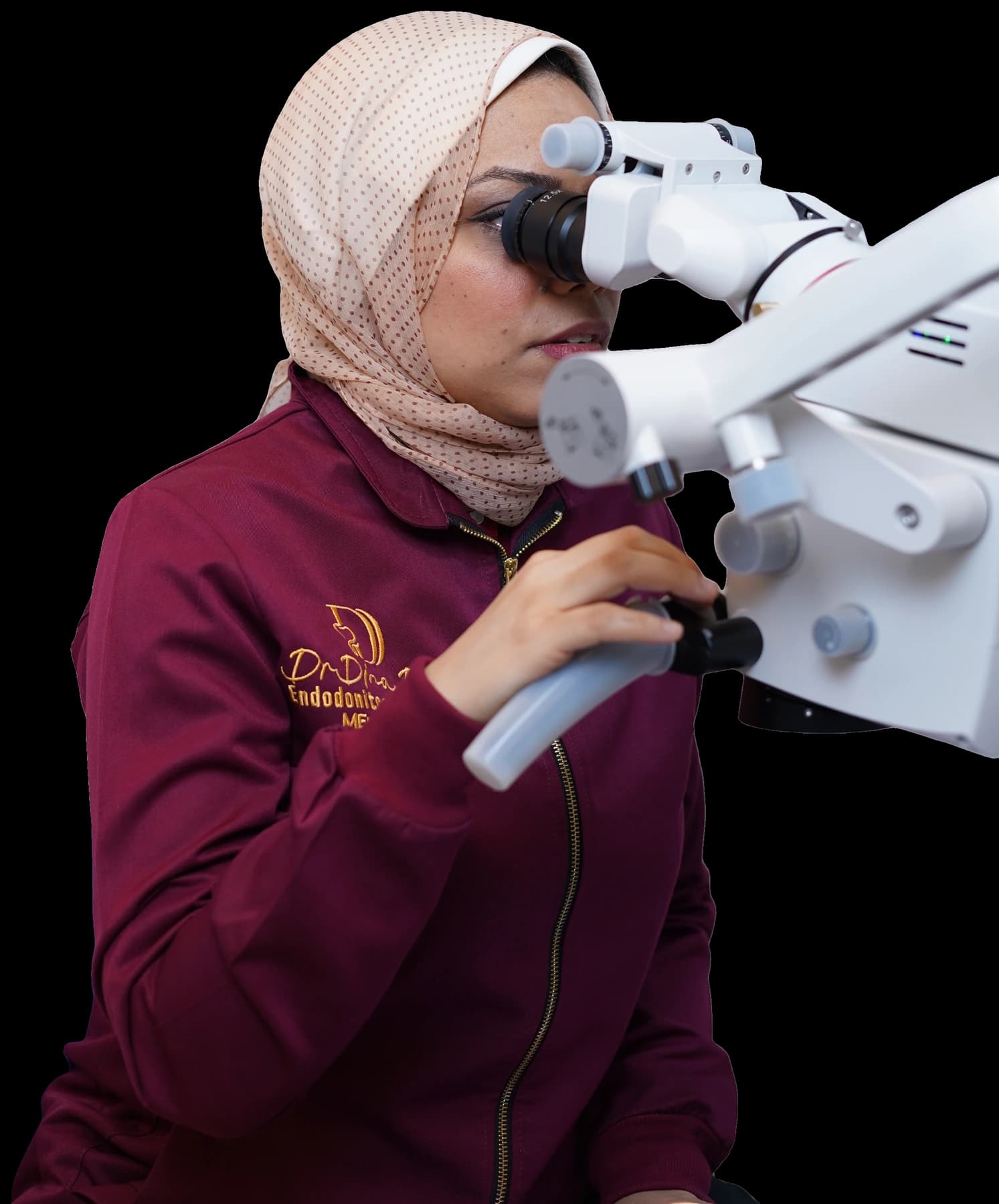 Dr. Dina Draz working with a dental microscope
